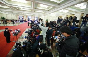Journalists make face-to-face interviews with high-level officials along the 100-meter-long "ministers' passage", also known as ministers' red carpet, at the Great Hall of People ahead of a plenary session of the fourth session of the 12th National People's Congress on Monday.